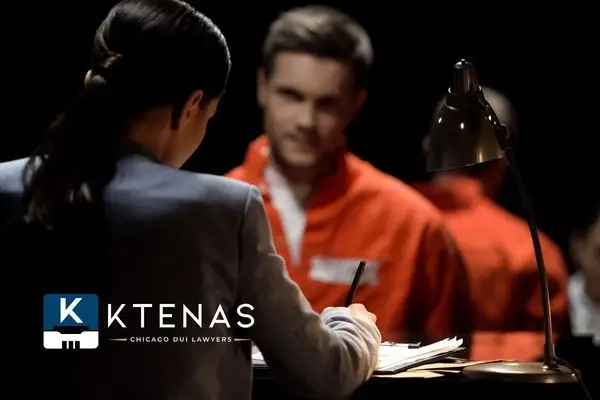 Women sitting in front of a man in an orange jumpsuit