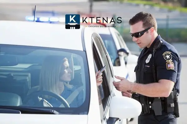 A police officer pulling over a women in a white car