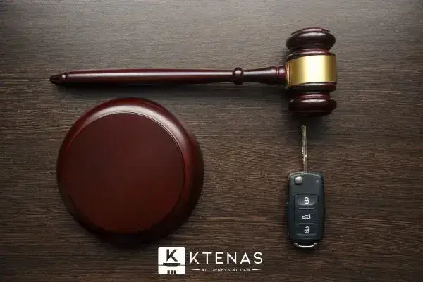 Car keys resting next to a mallet and gavel
