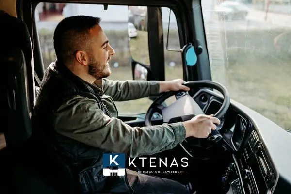 male truck driver sitting in the cab of a truck