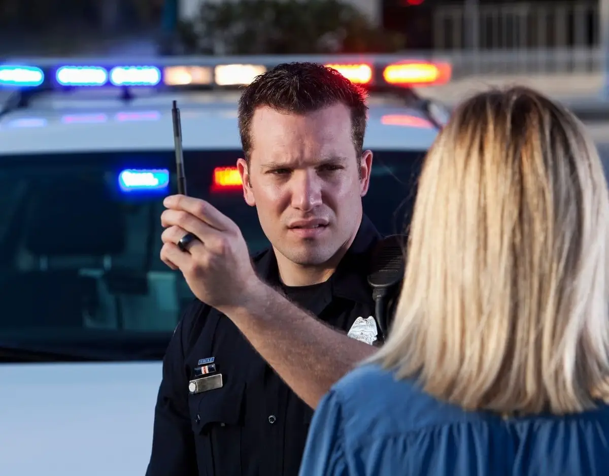 police officer giving eye field sobriety test to female