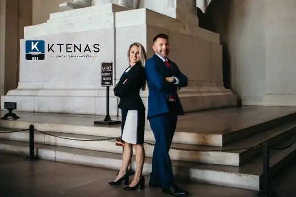 female and male attorneys standing back to back