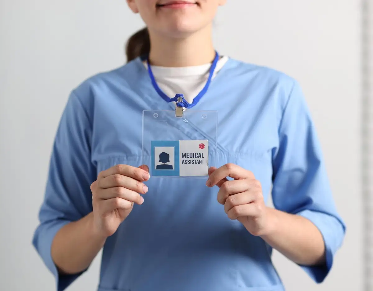 medical professional in scrubs with their license