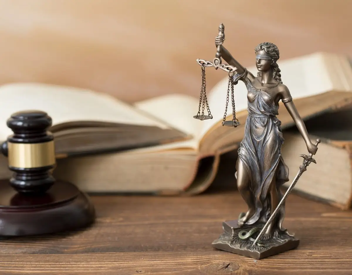 lady justice in front of books and a gavel