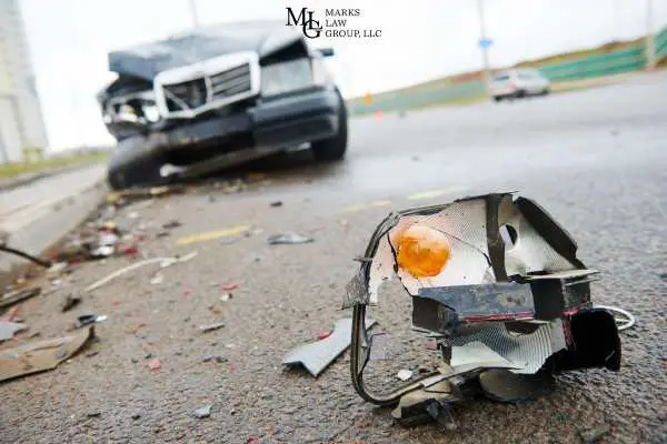 a side rearview mirror on a road after a car accident