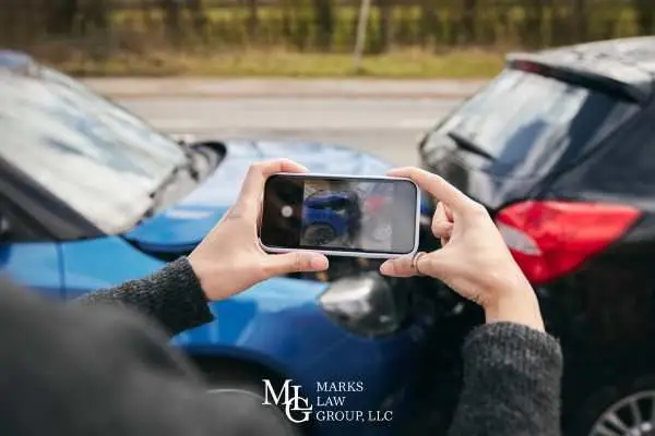 a man taking pictures of a car accident he was involved in