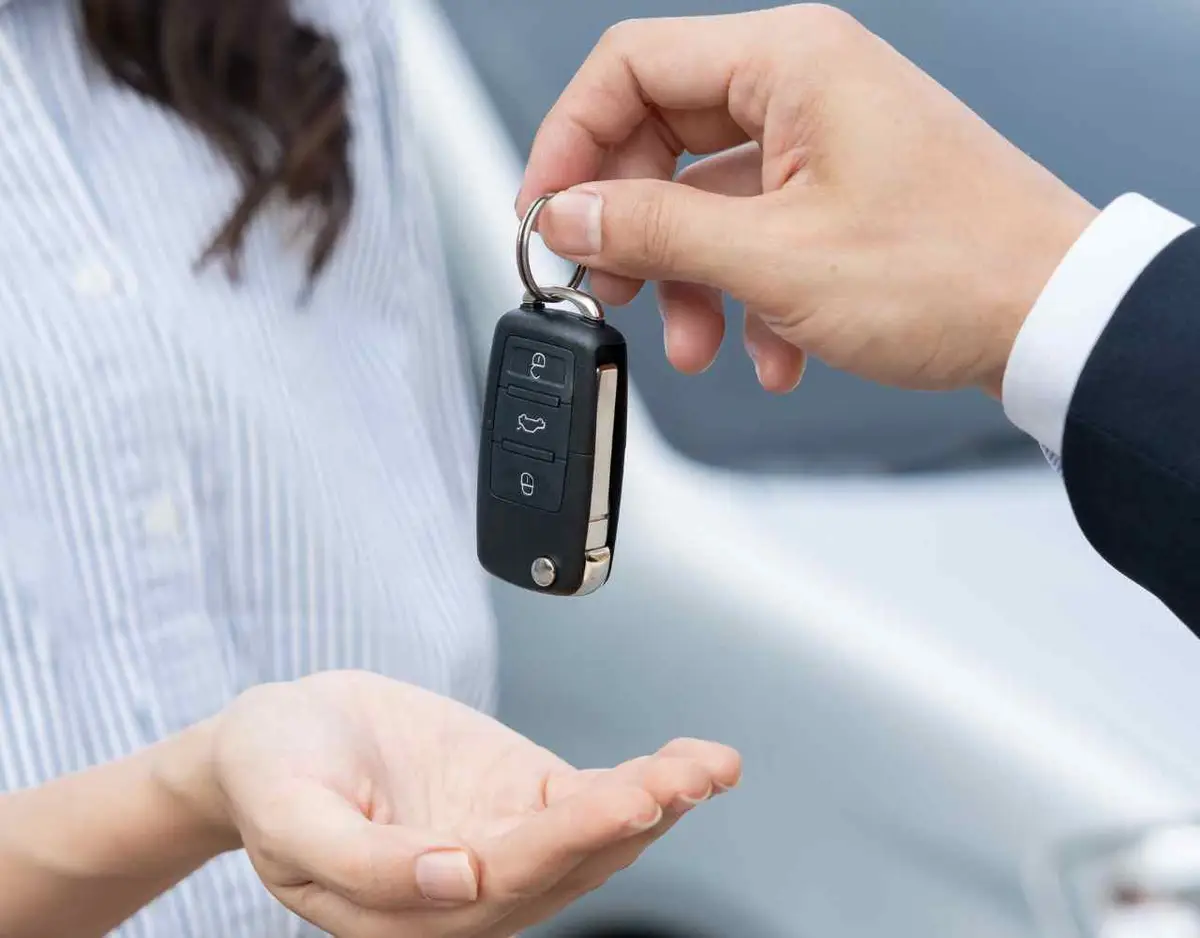 a woman picking up a rental car