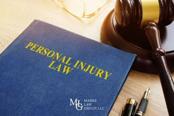 an attorneys desk with a gavel and injury law book on it