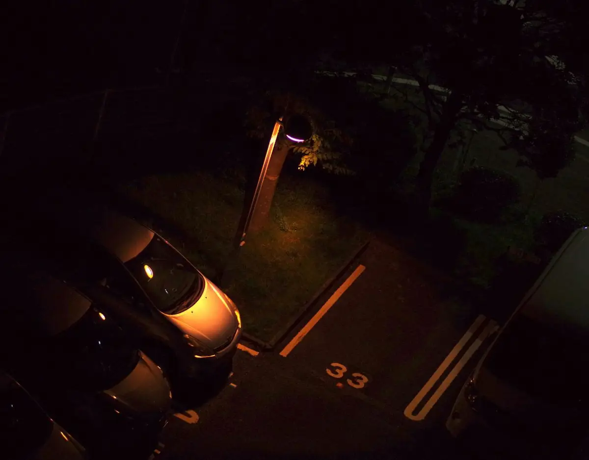an aerial photo of cars in a parking lot at night
