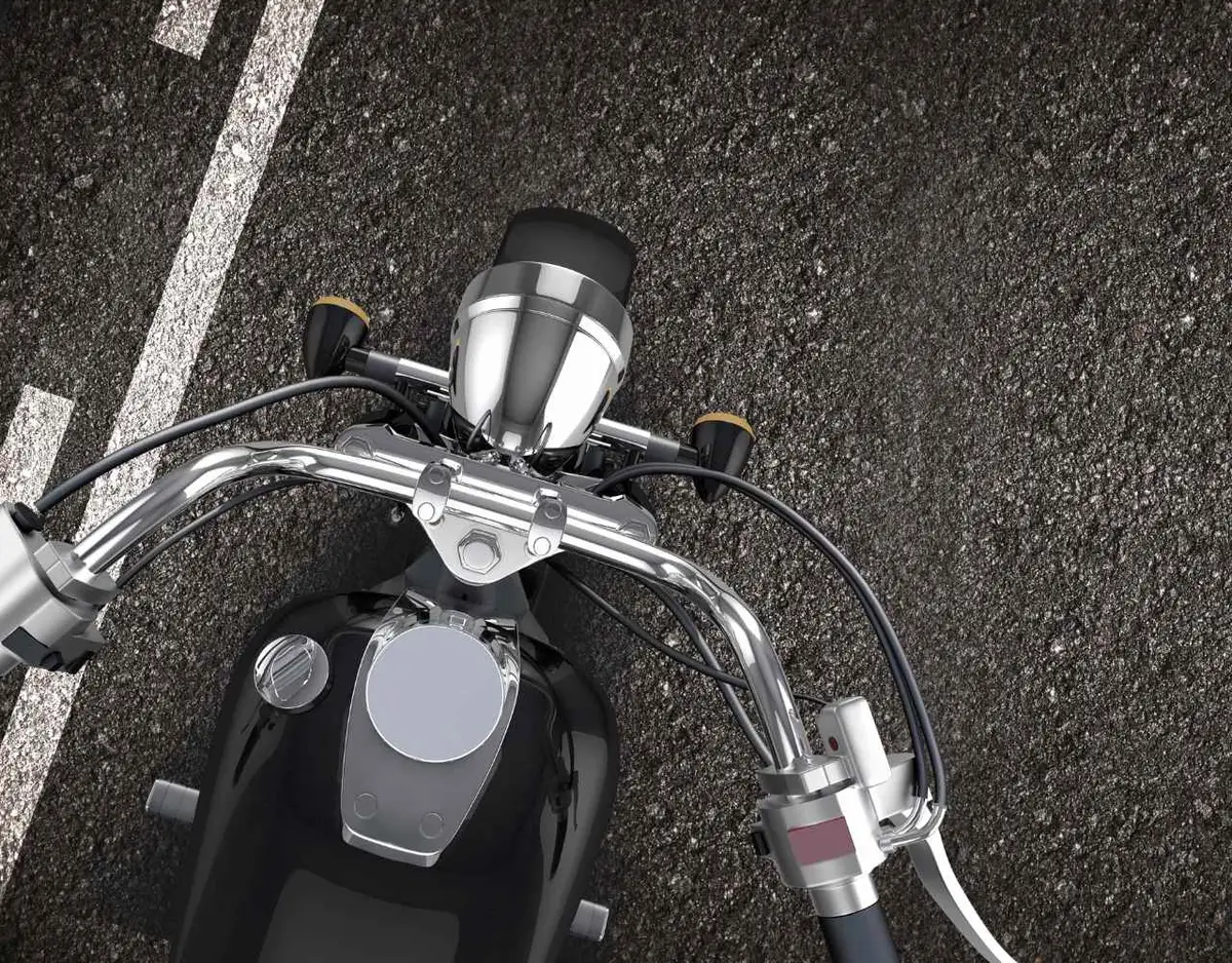 a motorcycle lane splitting on a road