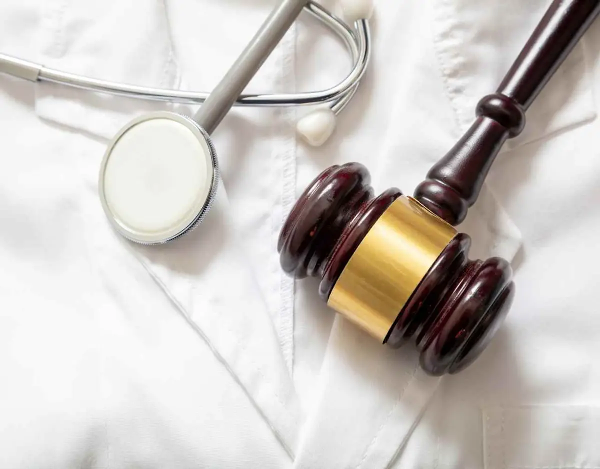 a stethoscope and gavel on a medical coat 