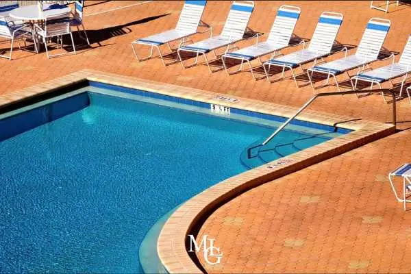 chairs next to a public pool