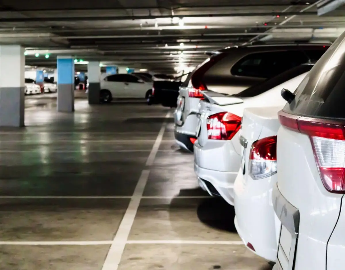 parking garage with row of cars parked on the right