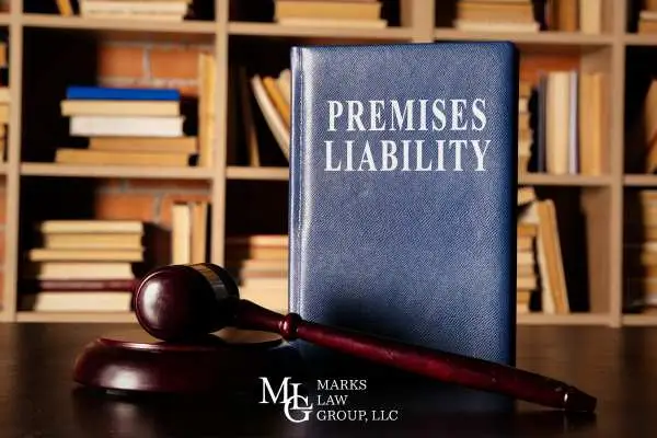 a law book covering premises liability and gavel on a desk in front of a bookshelf