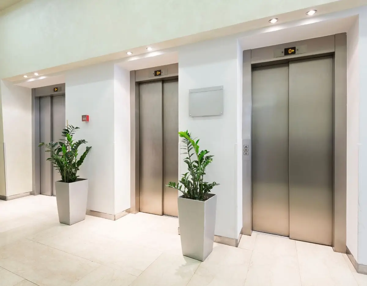 three elevators in bright lobby