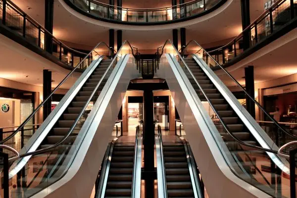 multiple escalators in dimly lit mall
