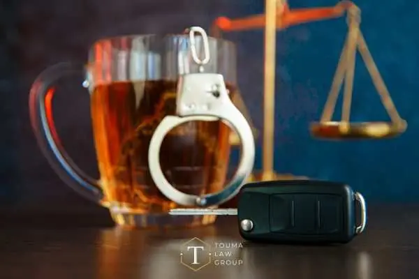 a table with beer, handcuffs, car keys, and scales on it