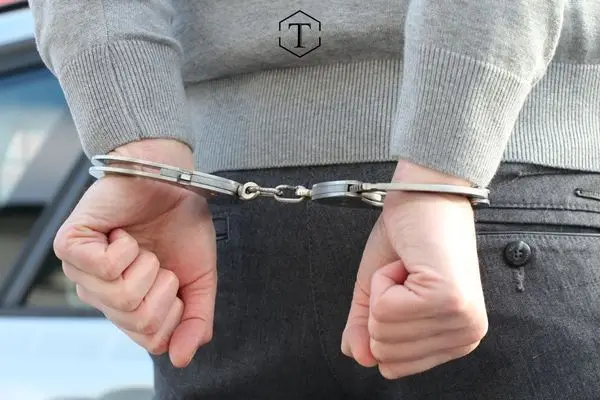a young man in handcuffs