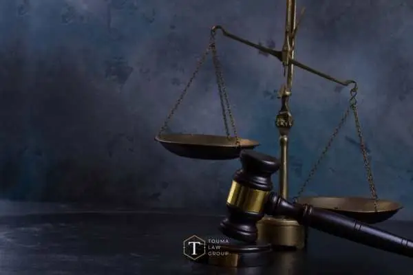 scales of justice and a gavel in front of a dark blue background