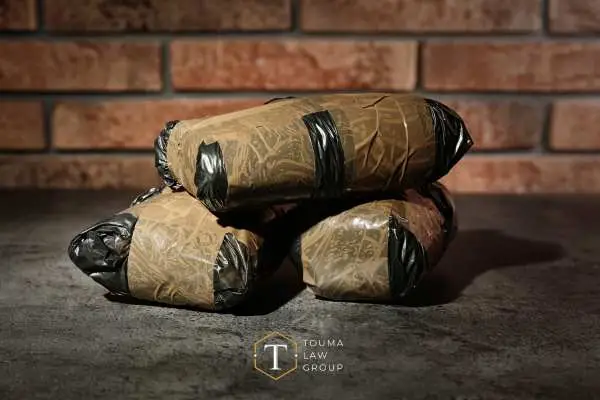 drug packages in front of a brick wall