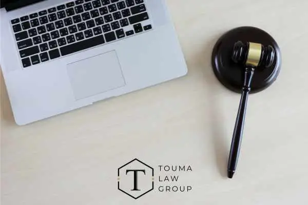 a laptop and gavel on a desk