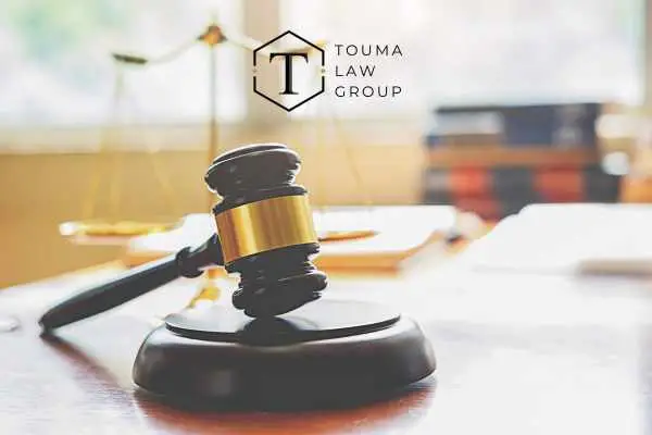 a gavel and legal books on a lawyers desk