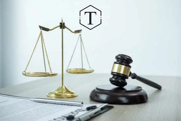 a gavel, scale, and clipboard with information regarding a sex crime charge for a client on an attorneys desk
