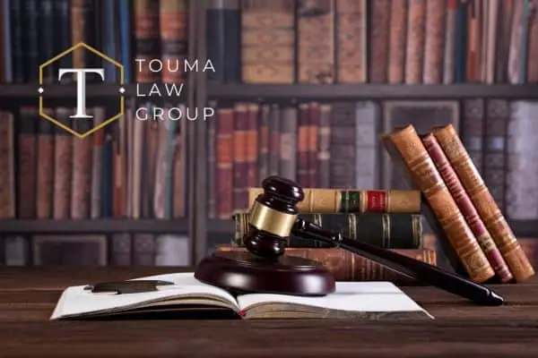 Gavel on open book with law books