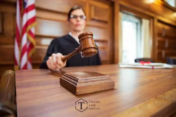 Judge striking gavel in domestic violence courtroom