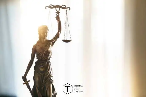 a photo of the statue of justice on a desk in front of a window