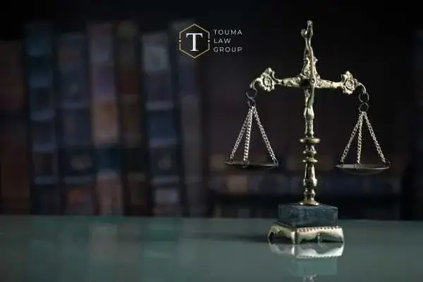scales of justice on a desk in front of law books