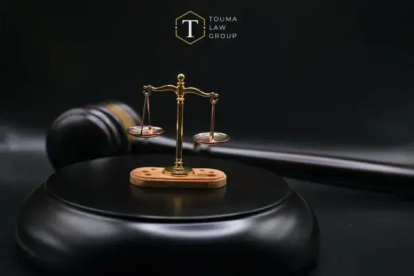 a gavel and scales on a desk in front of a black background
