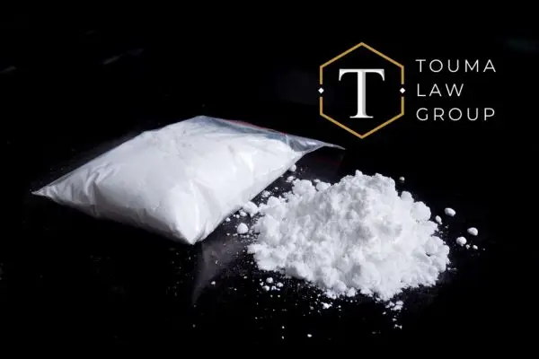 a bag of cocaine on a black desk