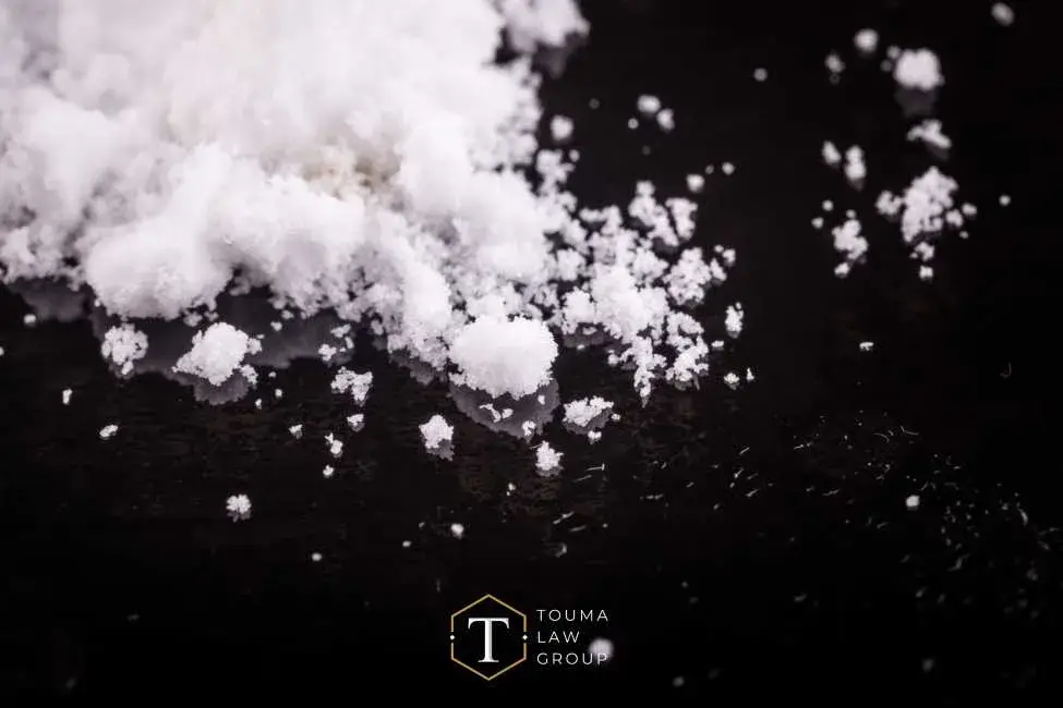a large quantity of a powdered drug on a black table