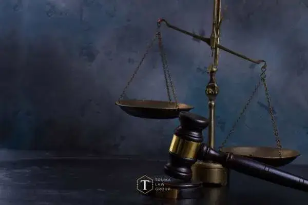 scales of justice and a gavel in front of a dark blue background