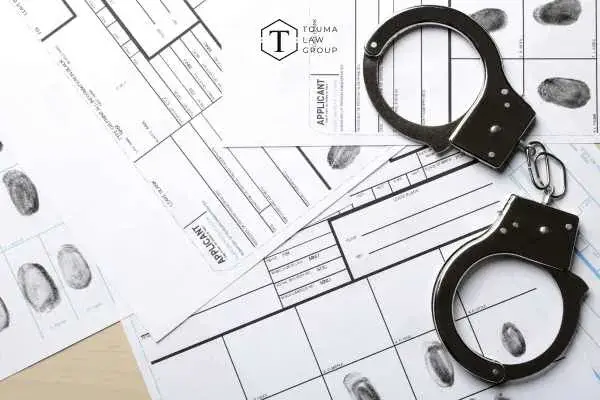 handcuffs and criminal records on a desk