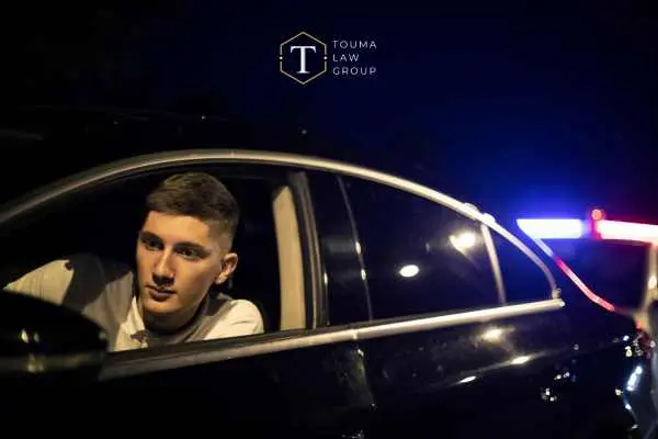 a young man in his car pulled over for suspicion of DUI
