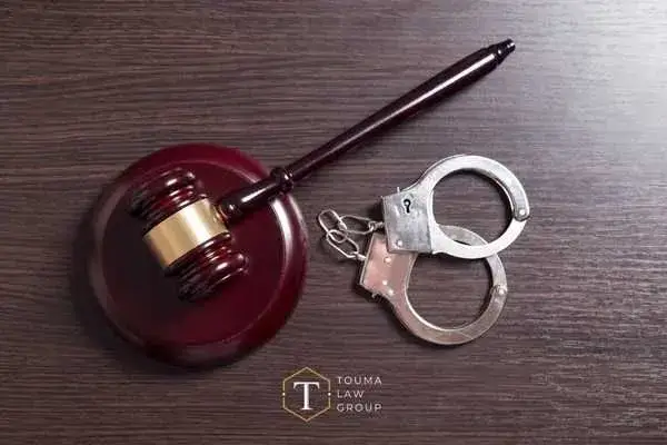 A judges gavel and handcuffs.