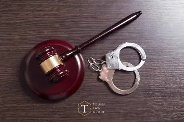 a desk with a gavel and handcuffs on it