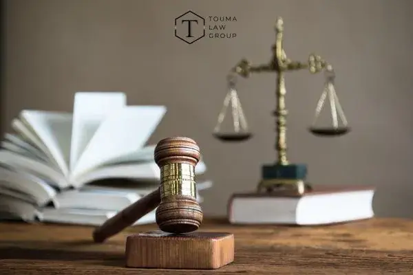 law books, scales, and a gavel on a desk in an office