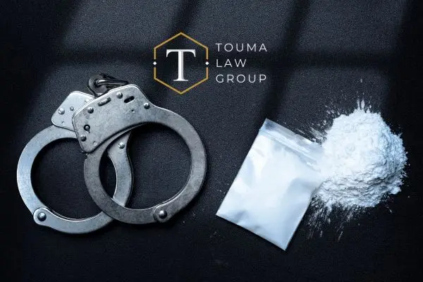 a bag of cocaine next to a pair of handcuffs