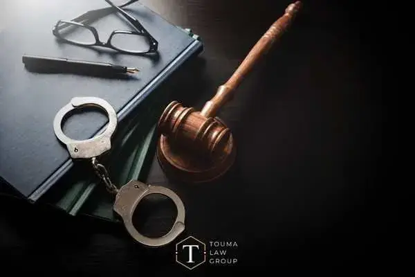 handcuffs, legal books, and a gavel on a desk