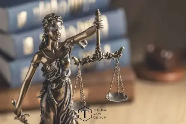 legal books and a statute of justice on a desk