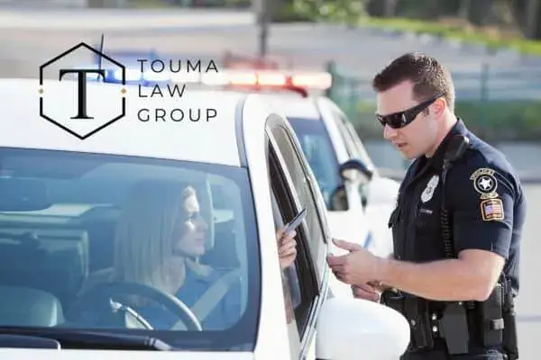 a woman receiving a ticket and thinking about her rights when pulled over
