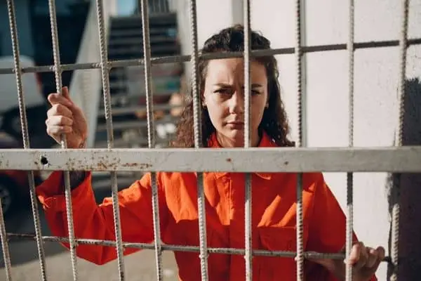 teenage girl in jail behind bars, Teenager was Charged with a Crime