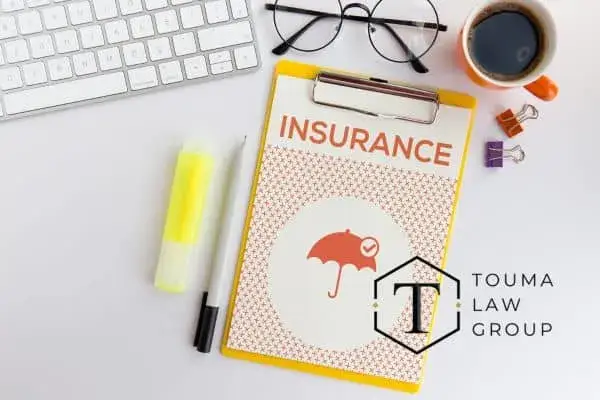 insurance forms next to a keyboard