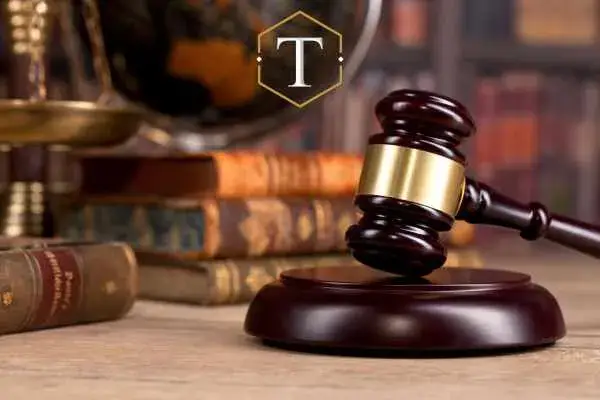 an image of a desk with a gavel, law books, and a globe on it.