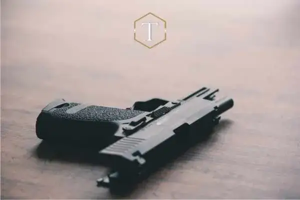 a handgun on a wooden desk