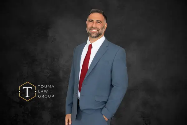 attorney adam in grey suit with red tie